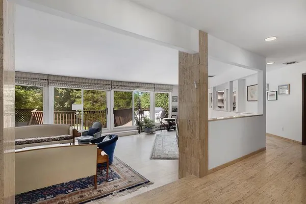 a living room with furniture and large windows