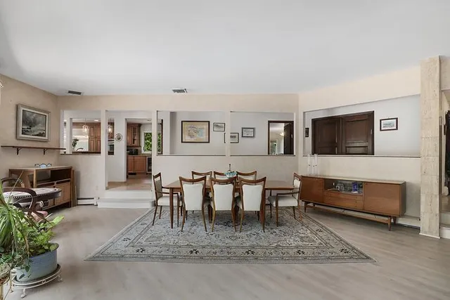 a living room with furniture a flat screen tv and a table