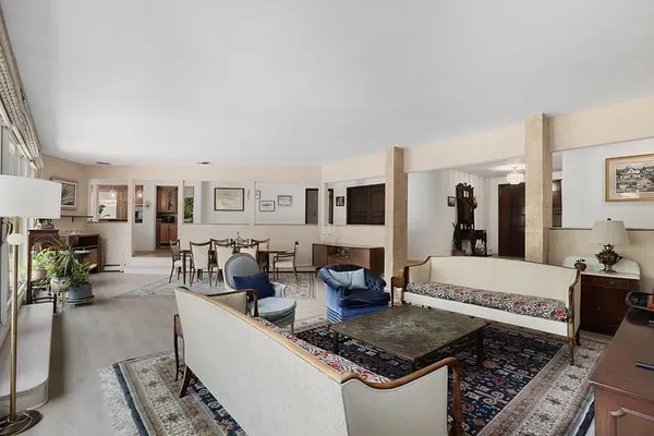 a living room with furniture and a lamp