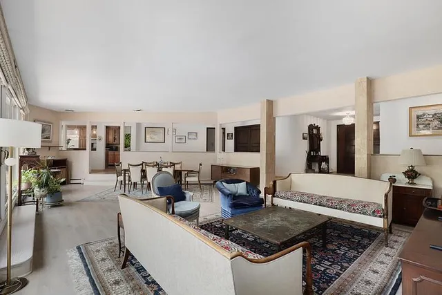 a living room with furniture and a lamp