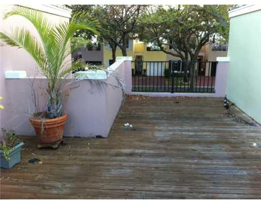 5955 Catesby Street, Unit 34 Boca Raton, FL 33433 - Photo 15 of 16 a view of a backyard with plants and tree