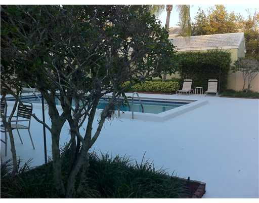 5955 Catesby Street, Unit 34 Boca Raton, FL 33433 - Photo 16 of 16 a view of a yard with plants and a bench