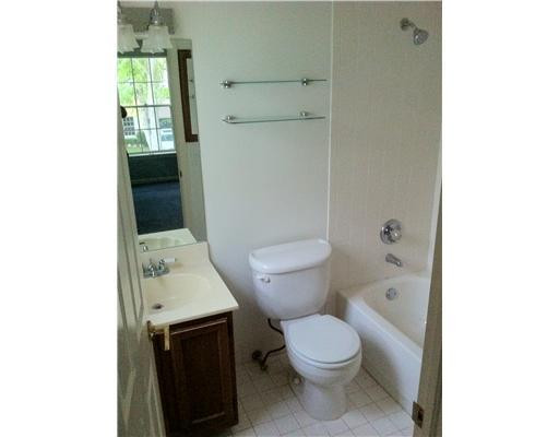 5955 Catesby Street, Unit 34 Boca Raton, FL 33433 - Photo 9 of 16 a white toilet sitting next to a bathroom sink and vanity