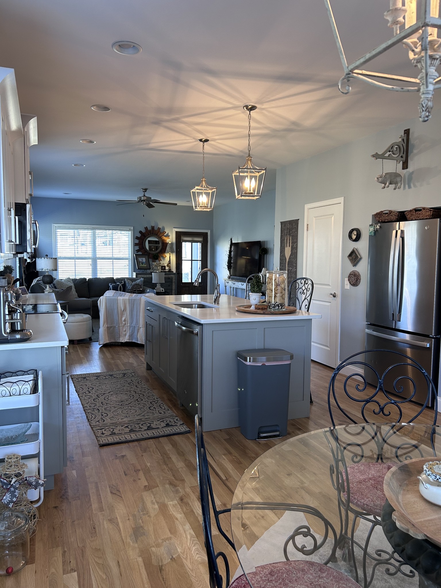 207 North Walnut Street Springfield, TN 37172 - Photo 3 of 14 a kitchen with stainless steel appliances granite countertop a stove a refrigerator a sink a dining table and chairs with wooden floor