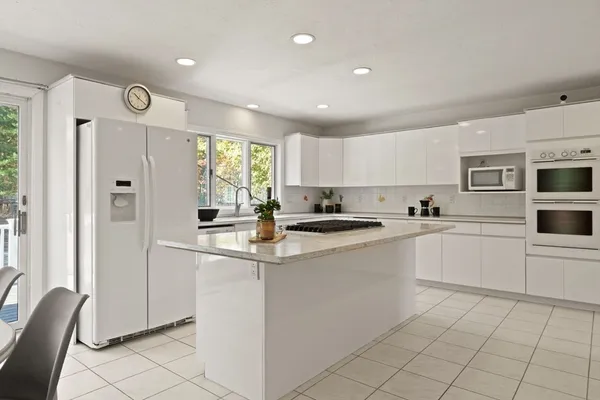 a kitchen with cabinets and window