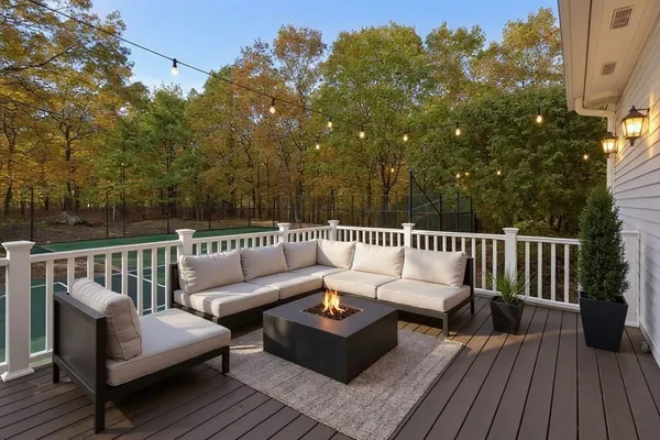 a roof deck with couches and wooden floor