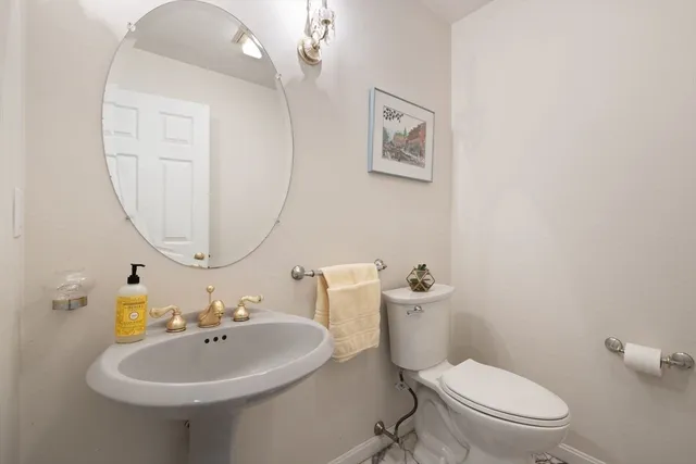 a bathroom with a sink a mirror and a toilet