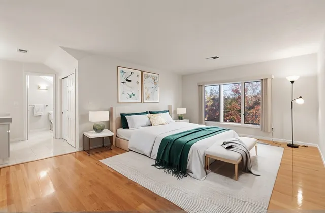 a bedroom with a large bed and a large window