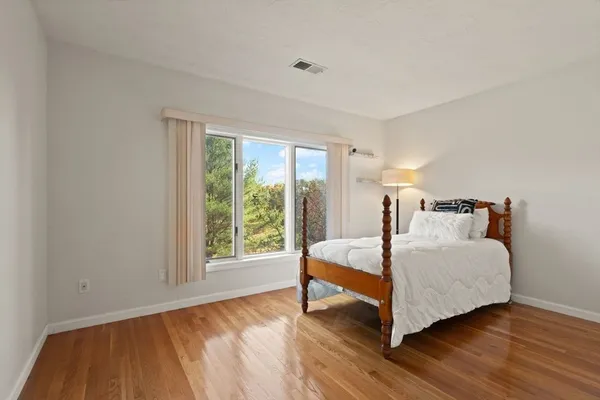 a bed room with a bed and a chair