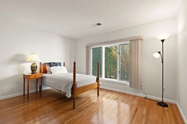 a bedroom with a bed and a large window