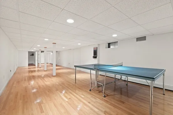 a room with wooden floor and pool table
