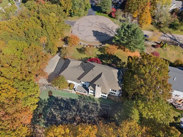an aerial view of a house with a yard and garden