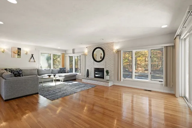 a living room with furniture large window and fireplace