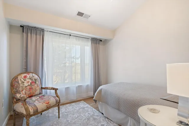 a bathroom with a granite countertop sink a toilet and shower curtain