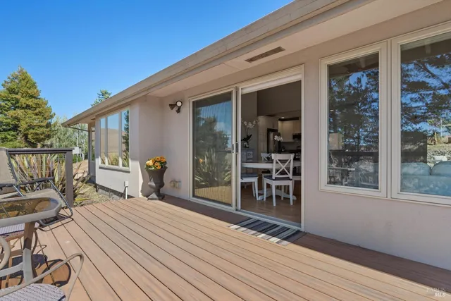 a view of balcony with wooden floor and seating space