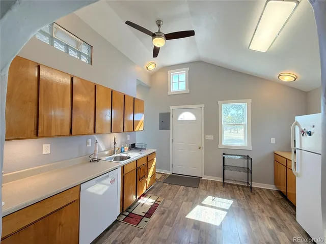 a kitchen with sink cabinets and wooden floor