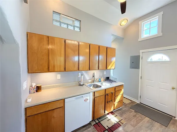 a room with a sink cabinets and window