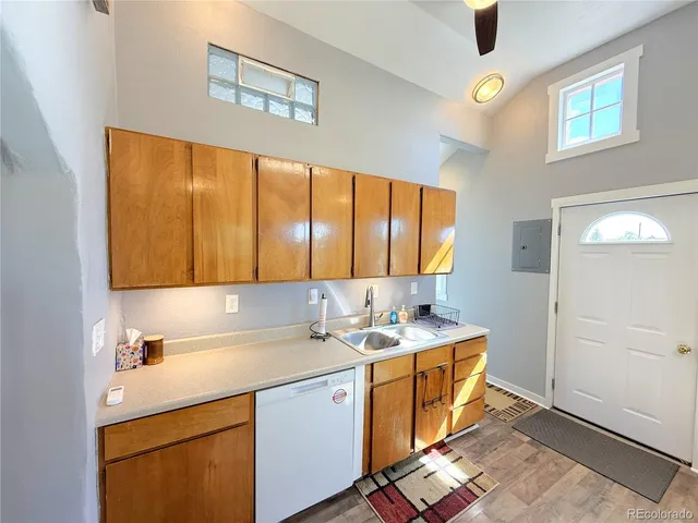 a room with a sink cabinets and window
