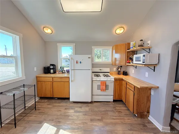 a kitchen with a sink and wooden floor