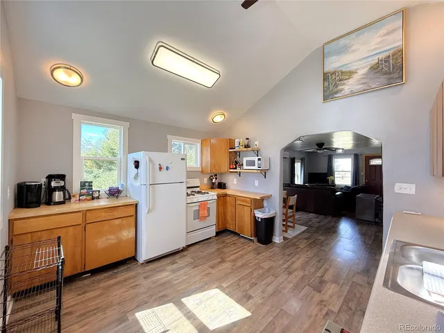 a kitchen that has a lot of cabinets a sink and appliances in it