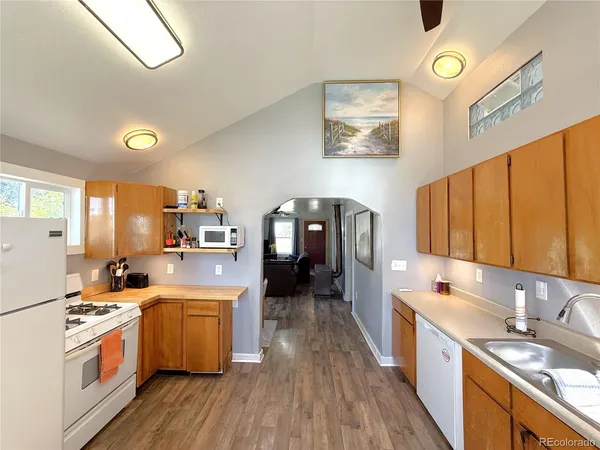 a kitchen with a sink cabinets and wooden floor