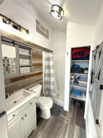 a bathroom with a sink a toilet and a shower