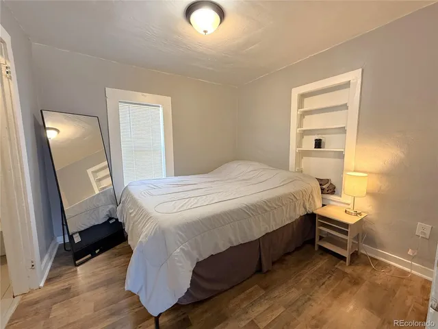 a bedroom with a bed and a mirror