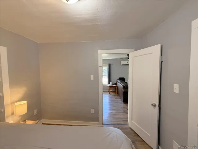 a bedroom with a bed and a mirror