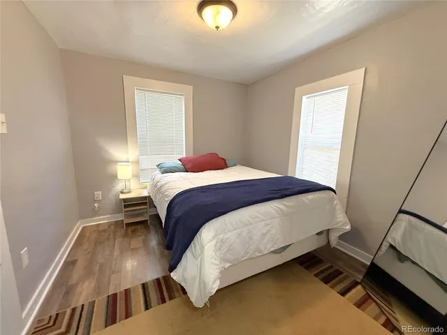 a bedroom with a bed and a view of hallway