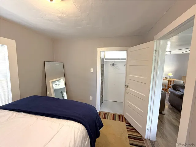 a bedroom with a bed and a large window
