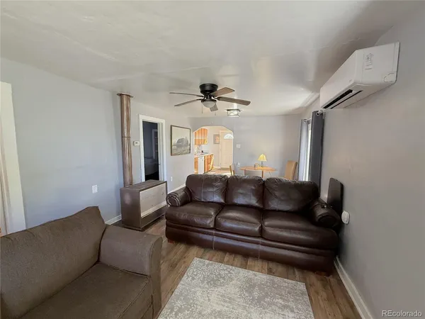 a living room with furniture and a chandelier