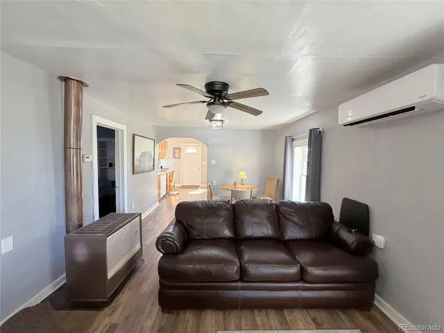 a living room with furniture and a ceiling fan