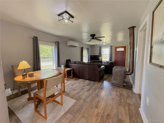 a view of a livingroom with furniture and a window