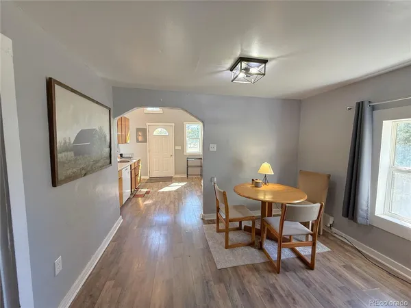 a view of a dining room with furniture window and wooden floor