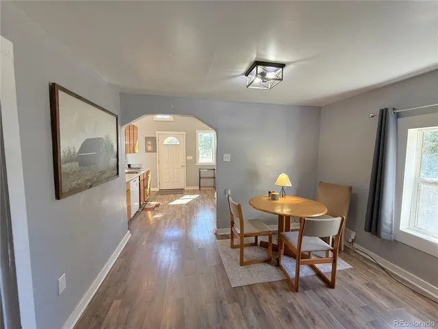a view of a dining room with furniture window and wooden floor