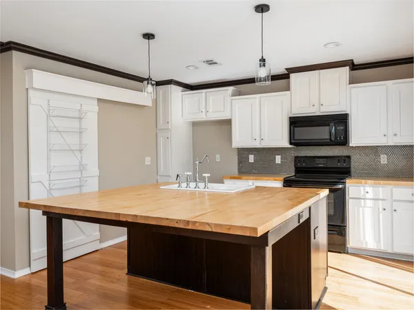 a bathroom with a granite countertop sink and a window