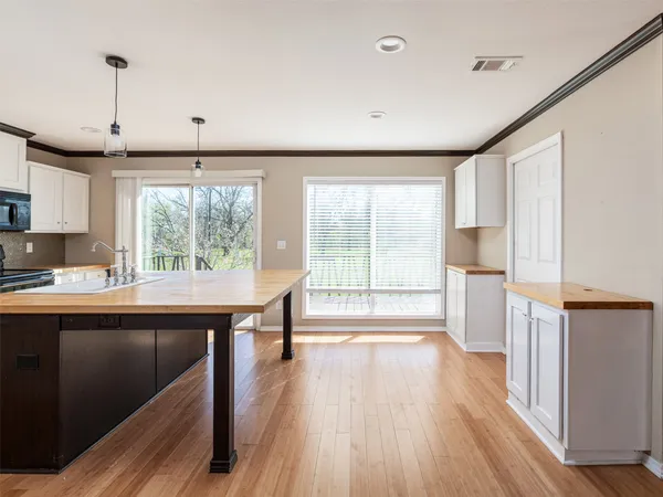 a kitchen with sink cabinets and wooden floor