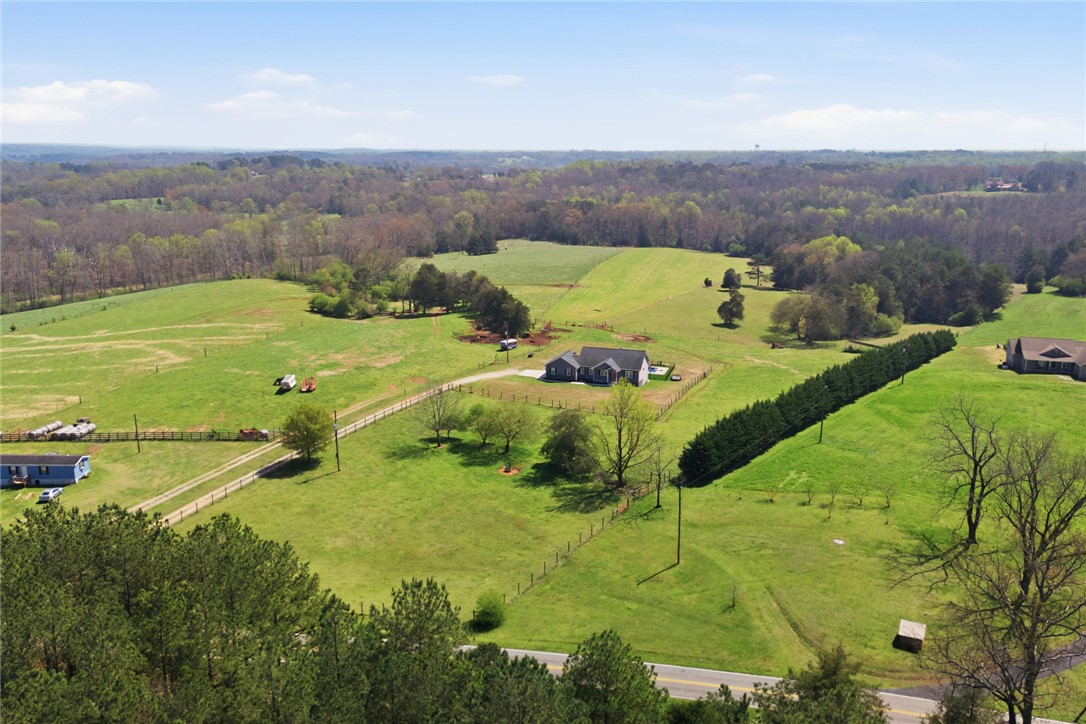 426 Oak Creek Road Seneca, SC 29678 - Photo 50 of 50 This expansive rural property features a charming home nestled amidst rolling green pastures.