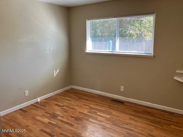 730 James Court Reno, NV 89503 - Photo 13 of 21 an empty room with wooden floor and a window