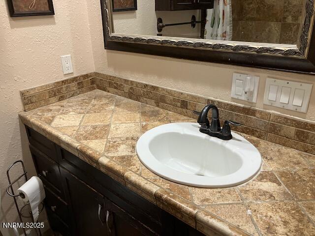 730 James Court Reno, NV 89503 - Photo 8 of 21 a bathroom with a granite countertop sink and a mirror