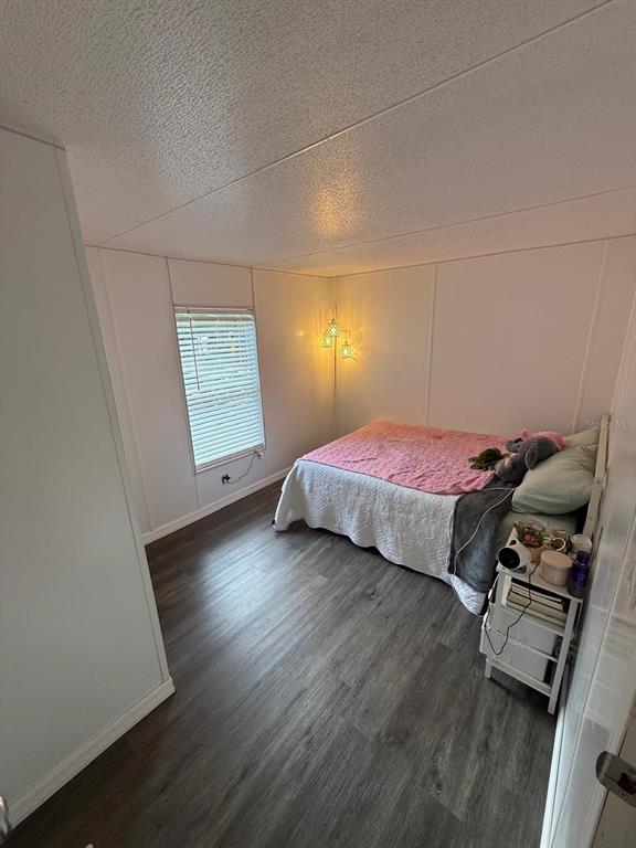 2433 East North Street Inverness, FL 34453 - Photo 10 of 11 a bedroom with a bed and wooden floor