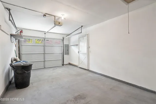 an aerial view of a house with a garden and lake view