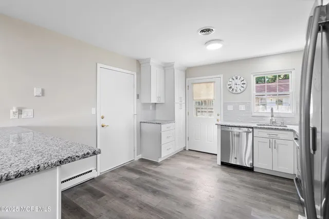 a kitchen with stainless steel appliances granite countertop a stove and a sink