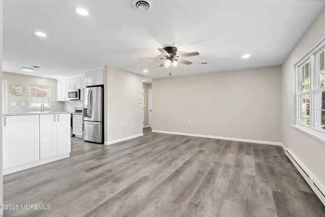 a living room with furniture a dining table and a chandelier