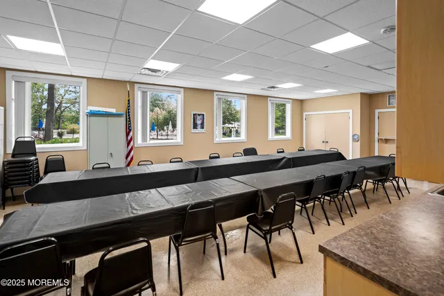 a view of a house with a big yard plants and large trees