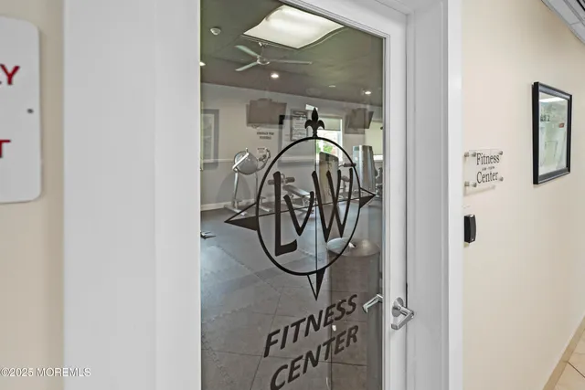 a front view of a house with a yard and potted plants