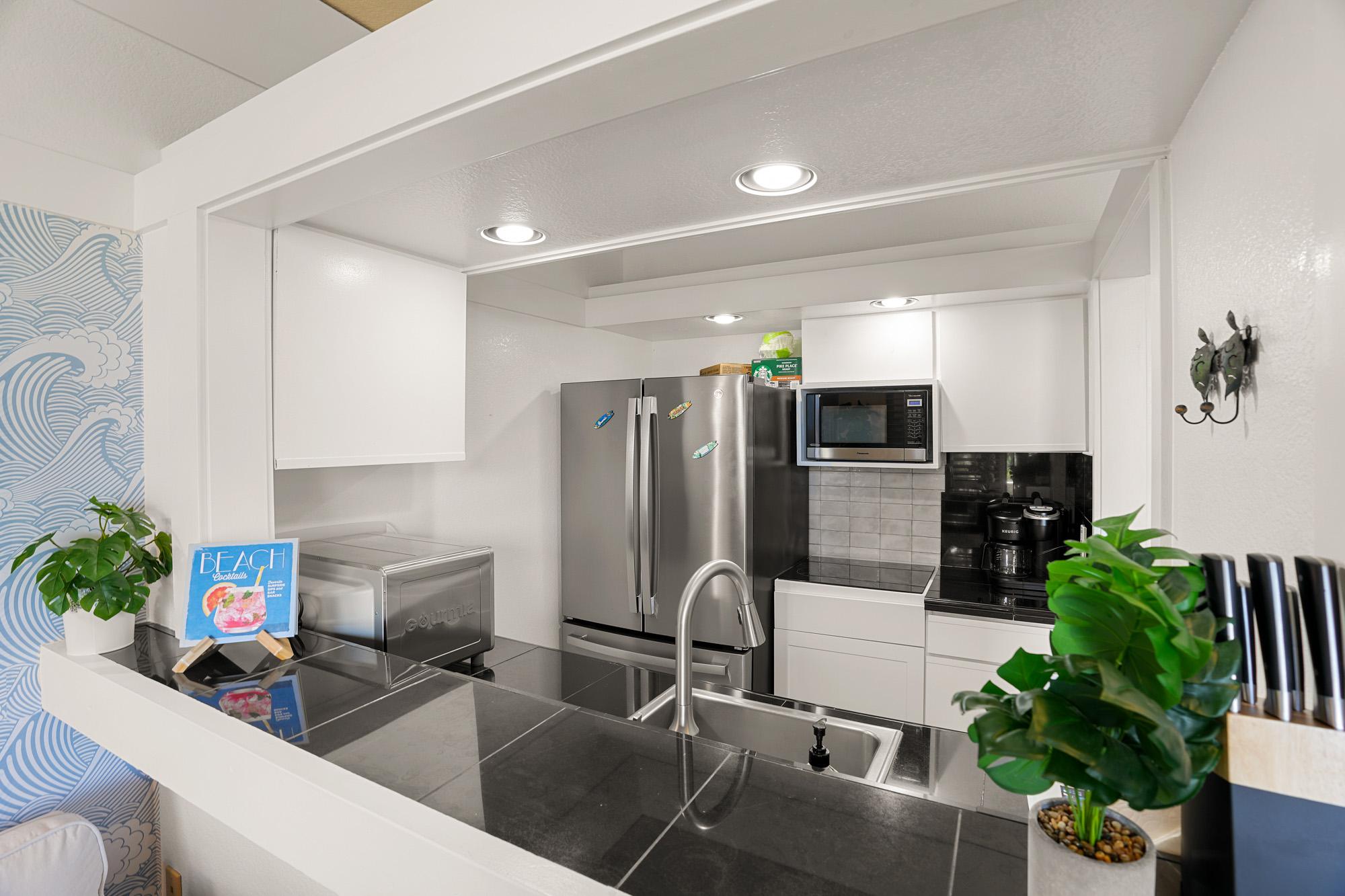 2253 Poipu Road, Unit 309 Koloa, HI 96756 - Photo 12 of 25 a living room with furniture potted plant and kitchen view