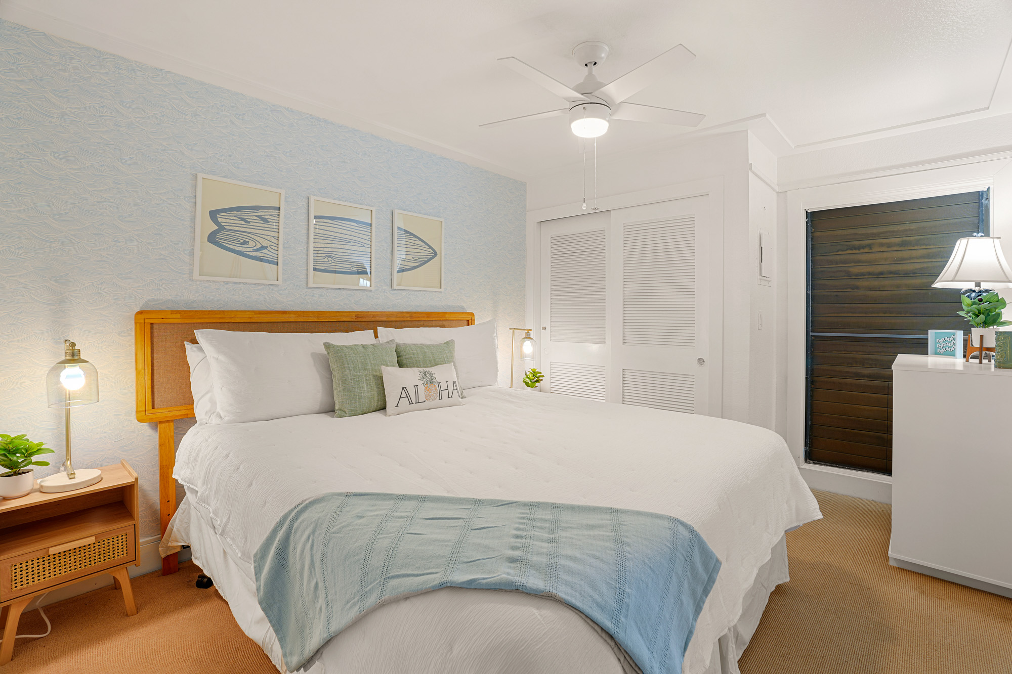 2253 Poipu Road, Unit 309 Koloa, HI 96756 - Photo 15 of 25 a bedroom with a bed and a chandelier