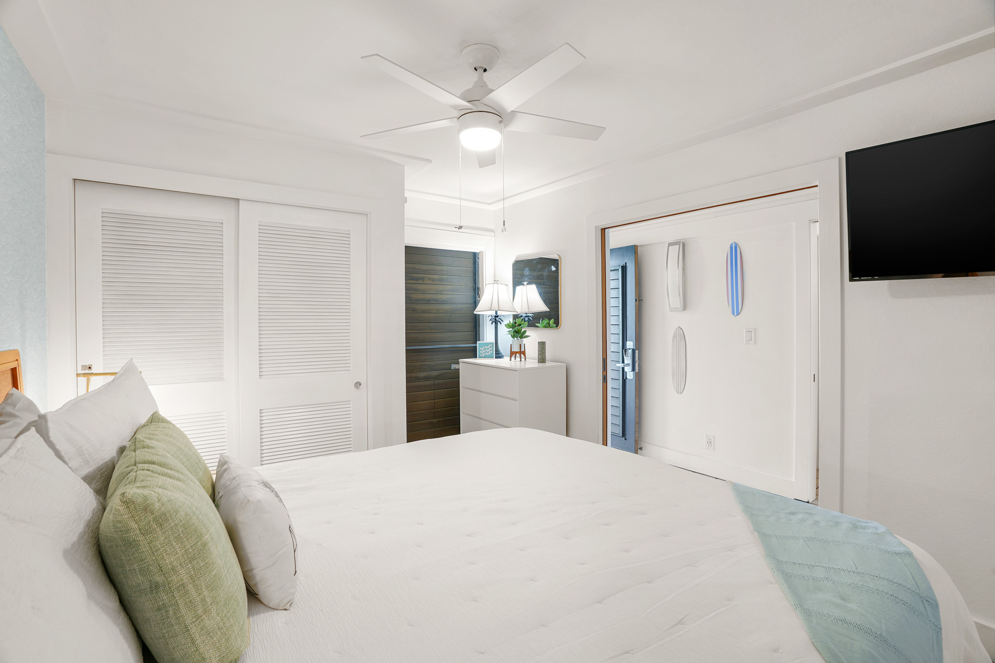 2253 Poipu Road, Unit 309 Koloa, HI 96756 - Photo 17 of 25 a bedroom with a large bed and a flat screen tv