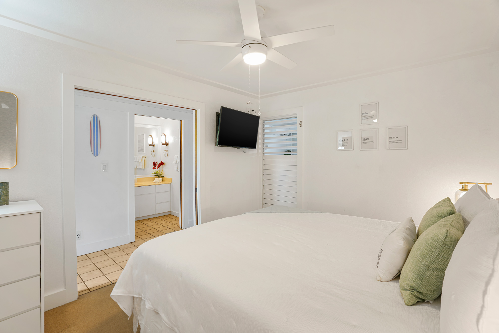 2253 Poipu Road, Unit 309 Koloa, HI 96756 - Photo 21 of 25 a bedroom with a bed and a flat screen tv